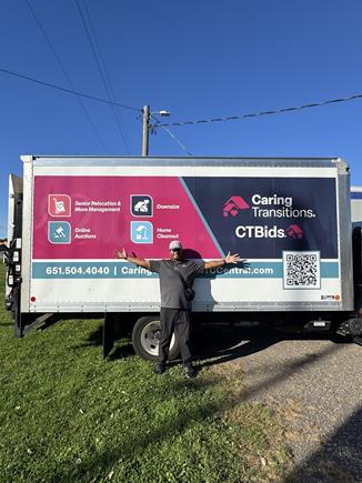 Man standing next to Caring Transitions Moving Truck